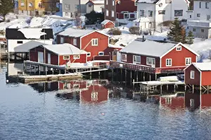 Wooden cabins at the waters edge in the town of Raine in the Lofoten Islands, Arctic, Norway, Scandinavia, Europe