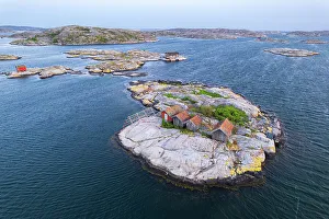 Sweden Prints: Wooden cottages on rocky islands at dusk