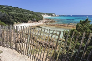 South Corsica Prints: The wooden fence frames the limestone rocks and turquoise sea, Sperone, Bonifacio