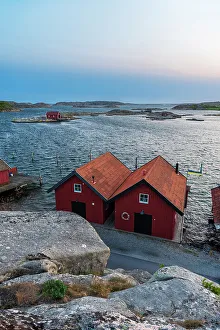 Wood Material Prints: Wooden houses on rocky coast at dusk