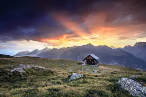 Engadine Prints: Wooden hut under fiery sky and clouds at sunset