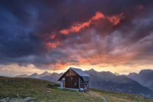 Muottas Muragl Prints: Wooden hut framed by fiery sky and clouds at sunset, Muottas Muragl, St
