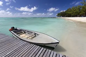 Ile Aux Cerfs Prints: Wooden jetty with a boat tied to it