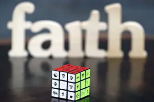 Interfaith Prints: Wooden letters forming the word FAITH and Rubiks cube with religious symbols