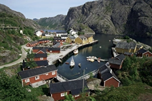 Fjord Prints: Wooden red houses on stilts over water at the fishing