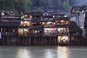 Wooden stilt houses on riverside, old town of Fenghuang, Hunan Province, China, Asia