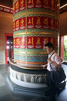 Chinatown Prints: Worshipper and Viarocana Buddhist prayer wheel, Buddha Tooth Relic Temple in Chinatown