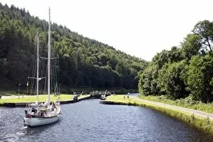 Yacht approaching lock, Crinan Canal, Highlands, Scotland, United Kingdom, Europe