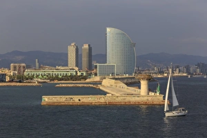 Typically Spanish Gallery: Yacht sails past La Barceloneta and the waterfront, Port Olimpic in distance, late afternoon