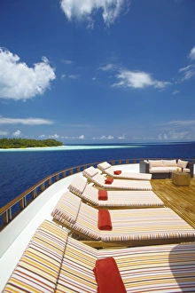 Lounge Chairs Prints: Yacht and tropical island, Maldives, Indian Ocean, Asia