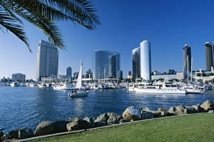Yacht in front of waterfront skyline seen across