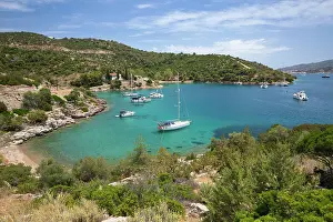 Anchor Prints: Yachts anchored in rocky cove with crystal clear turquoise water at Russian Bay