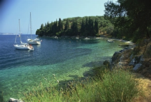 Yachts moored offshore in Kalami Bay on the coast