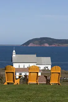 Quebec Prints: Yellow Adirondack chairs overlooking church on an island in the Gulf of St