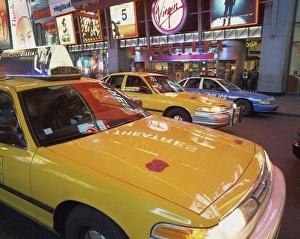 Cabs Prints: Yellow cabs on the street at night in Times Square
