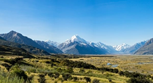 River Valley Prints: Yellow grass field with large mountains in the distance, South Island, New Zealand