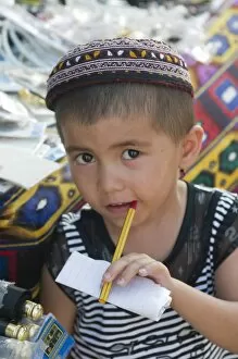 Young boy with pen in his mouth, Khiva, Uzbekistan, Central Asia, Asia