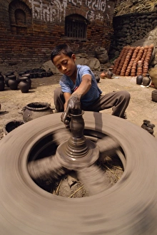 Pottery Prints: Young boy throwing a pot