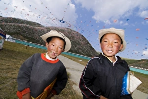 Sichuan Prints: Two young boys and thousands of prayer flags, Tagong Grasslands, Sichuan, China, Asia