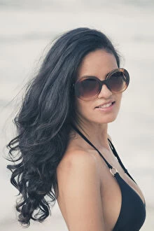 Eye Contact Gallery: Young Brazilian (Latin American) (Latina) woman on the beach in a bikini and sunglasses