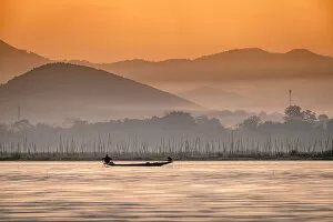 Rippled Gallery: Young fisherman with net at sunrise, Inle Lake, Shan state, Myanmar (Burma), Asia