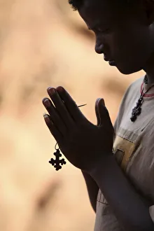Ethiopia Prints: Young man praying in Lalibela, Ethiopia, Africa