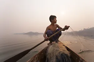 Fishing Net Prints: A young man pulls in his nets at the end of the day on Indawgyi Lake, Kachin State