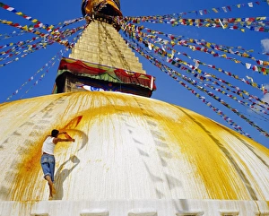 Bunting Prints: Young man throwing saffron water on the stupa in order