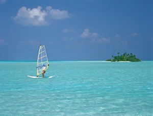 Images Dated 27th November 2009: Young man windsurfing near tropical island and lagoon in the Maldives, Indian Ocean