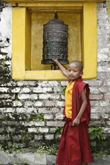 Images Dated 24th July 2007: Young monk and prayer wheel, Swayambhunath temple, Kathmandu, Nepal, Asia
