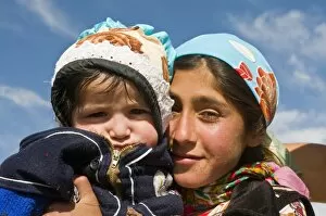 Young Pamir girl holding her little brother, Tajikistan, Central Asia, Asia