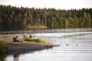 Young people relaxing beside lake, Savonlinna, Saimaa Lake District, Savonia