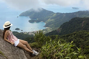 Contemplating Gallery: Young woman looking out over the Green Coast (Costa Verde) from Papapagaio peak