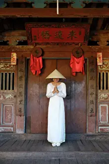 Portrait Prints: A young woman in a Non La conical hat and a traditional Ao Dai dress in the historical centre