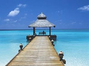 Seat Prints: Young woman sitting on bench at the end of jetty, Maldives, Indian Ocean, Asia