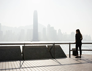 Kowloon Prints: Young woman standing on Tsim Sha Tsui Waterfront, Kowloon, Hong Kong, China, Asia