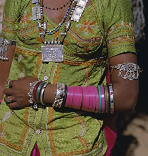 Wearing Prints: Young woman wearing jewellery around neck and on her arms