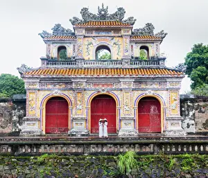 Adults Prints: Two young women in traditional dress standing at the Western gateway to the Purple