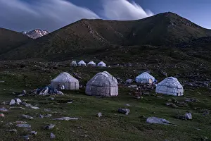 Heritage Site Prints: Yurts are beautifully arranged in the mountains around Kol-Ukok lake at dusk