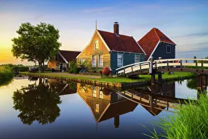 Stillness Prints: Zaanse Schans house stands by the water during summer sunset with bright reflections in Zaanstad