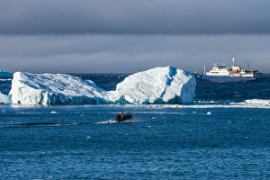 Cruising Prints: Zodiac cruising back to a cruise ship anchoring behind an iceberg, Brown Bluff, Antarctica