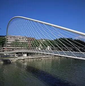Zubizuri curved pedes trian bridge acros s the Bilbao River
